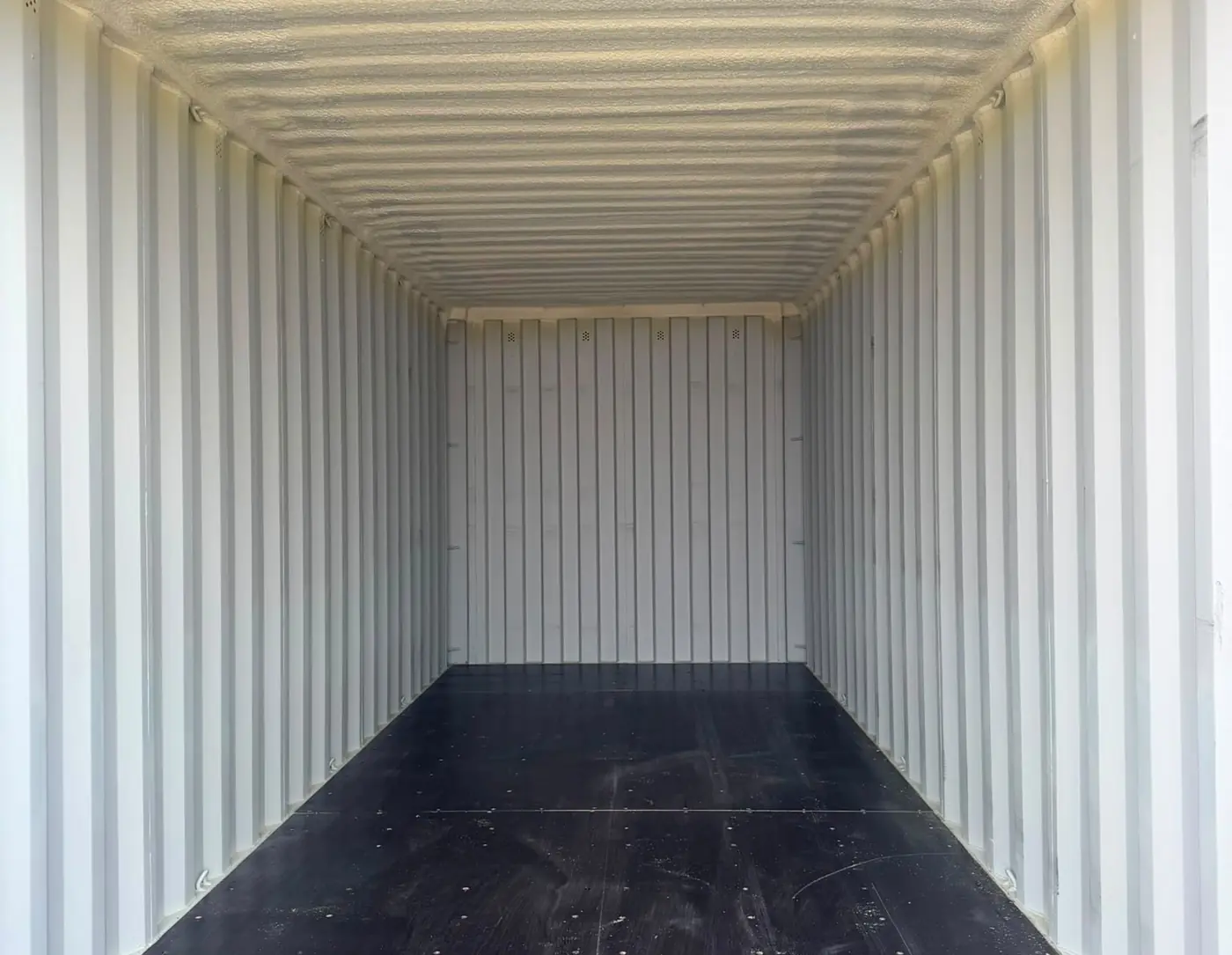 Inside a clean, empty steel storage container
