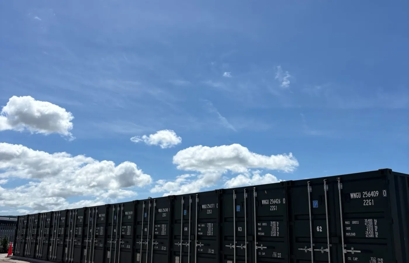 Row of storage containers under blue sky