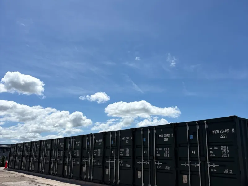 Row of storage containers under blue sky
